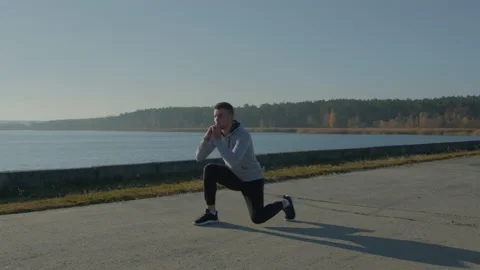 Young Man Is Doing Forward Lunges Stock Footage 165676620