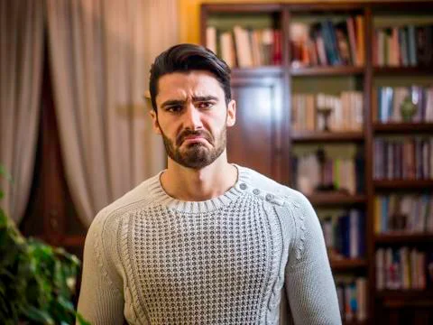 Young man doing funny face, looking disgusted Stock Photos