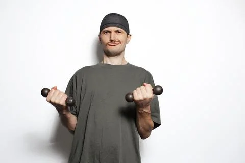 Young man doing gym with two small dumbbells isolated on white background. .. Stock Photos
