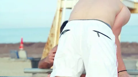 Young man doing gymnastic exercises on a sports crossbar. Stock Footage 79185832