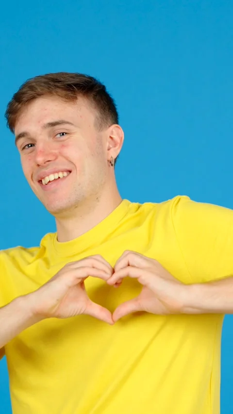 Young man doing heart shape with hands Stock Footage 254458265