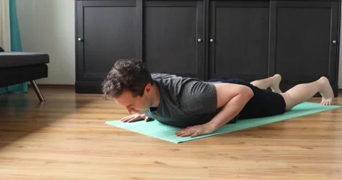 Young man doing her workout at home - superman exercise Stock Footage 131314252