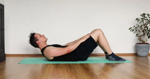 Young man doing her workout at home - crunch exercise Stock Footage 133573482
