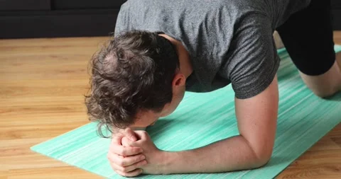 Young man doing his workout at home - plank exercise Stock Footage 133574041