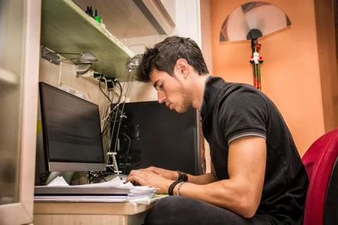 Young Man with Doing Homework at Computer Desk Stock Photos