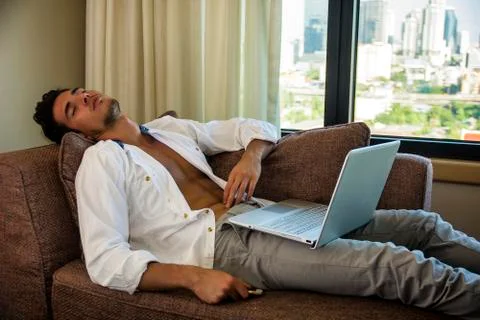 Young Man Doing Homework on Laptop in Bedroom Stock Photos