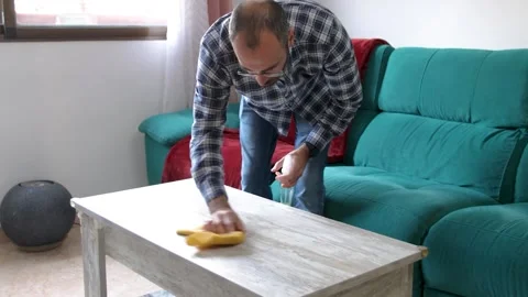 Young man doing housework. Cleaning the table at home. Stock Footage 262530596