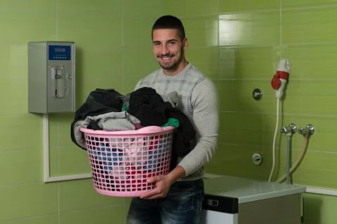 Young man doing housework laundry Stock Photos