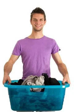 Young man doing the laundry Stock Photos