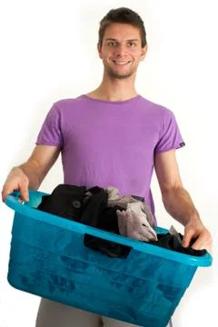 Young man doing the laundry Stock Photos