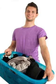 Young man doing the laundry Stock Photos