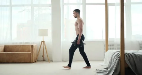 Young man doing lunges exercise with dumbbells Stock Footage 156520897