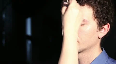Young man doing make-up - brush to apply powder Stock Footage 11010571
