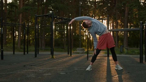 Young Man Doing Mobility Exercises in Outdoor Gym in Forest Stock Footage 315180054