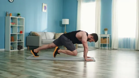 Young Man Is Doing Mountain Climber Exercise Stock Footage 135310747