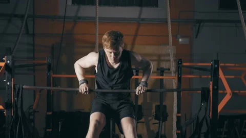 Young man doing muscle up exercise Stock Footage 153058325