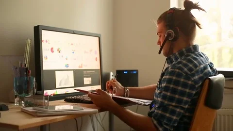 Young man doing notes in front of the computer and showing thumbs  Stock Footage 75146544