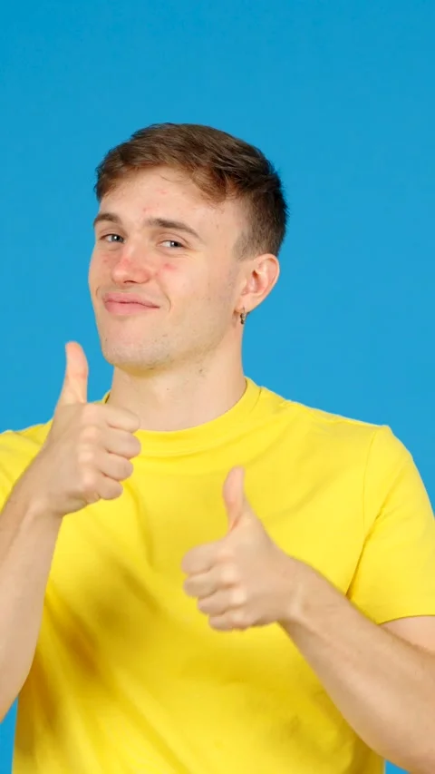 Young man doing ok sign with thumbs up Stock Footage 254458268