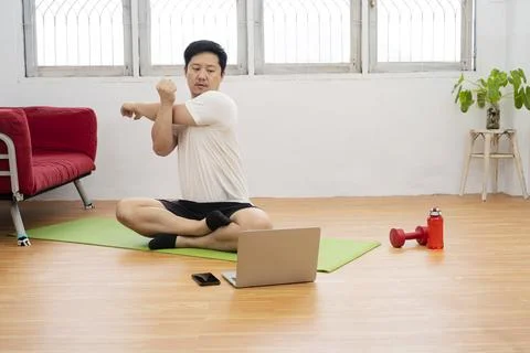 Young man doing plank exercise with online tutorial at home, free space 스톡 사진