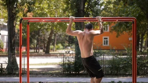 Young man is doing pull ups on the exercise ladder Stock Footage 79278003