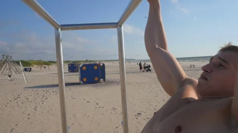 Young man doing pull ups on horizontal bar Video stock 84041814