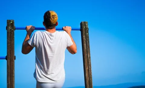Young man doing pullups Stock Photos