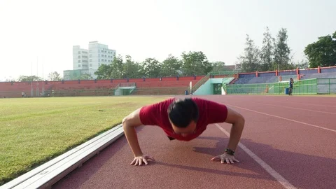 Young man doing push ups outdoor Stock Footage 89327059