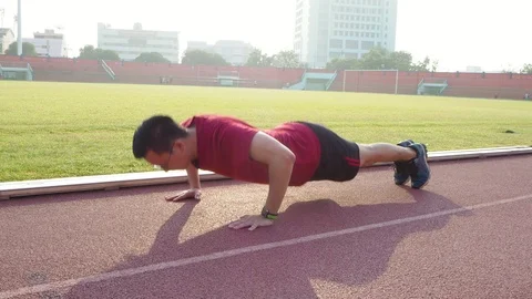 Young man doing push ups outdoor Stock Footage 89373658