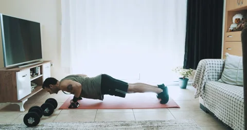 Young Man Is Doing Push-Ups Exercises On Workout At Home 動画素材 143999474