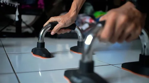 Young man doing push ups using a handle bar Stock Footage 289696015