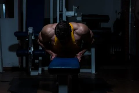 Young man doing push ups in gym Stock Photos