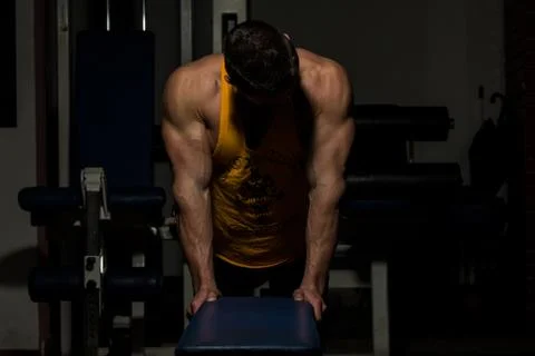 Young man doing push ups in gym Stock Photos