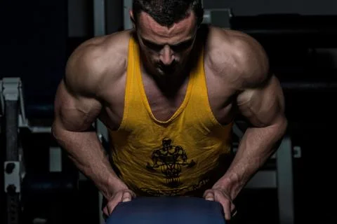 Young man doing push ups in gym Stock Photos
