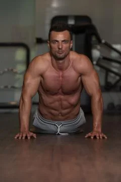 Young Man Doing Push Ups On Floor Stock Photos
