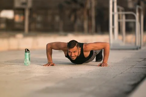 Young man doing push ups. Workout exercise. Training outdoor. Sports and fitness Stock Photos