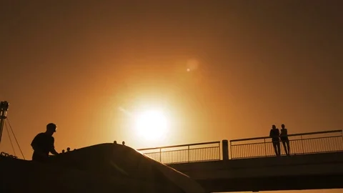 Young man doing ramp jump stunt on bmx bicycle on sunset slow motion Stock Footage