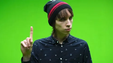 Young man doing rejecting symbol against a removable chroma key background Stock Footage 155585361