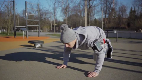 Young man doing running plank outdoors Stock Footage 129604762