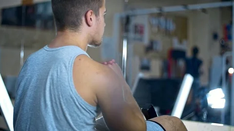 Young man doing sit-ups on abdominal bench and getting tired abdominal exercises Stock Footage 81422794