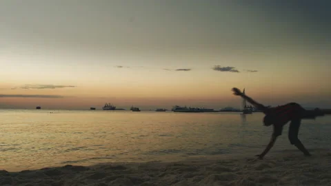 Young man doing somersault On The Beach  Tanzania  Africa Stock Footage 131078565