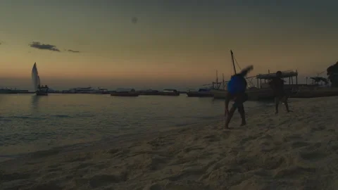 Young man doing somersault On The Beach  Tanzania  Africa Stock Footage 131079694