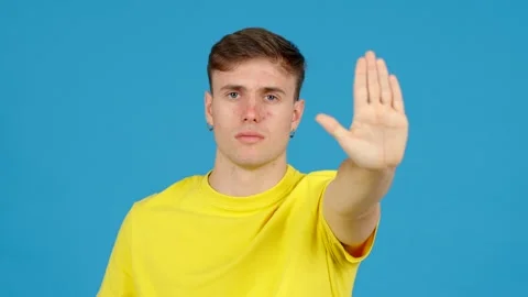 Young man doing stop signal with hand Stock Footage 253845778