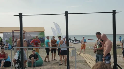 Young Man Doing Street Workout on The Beach during the competition Stock Footage 60688141