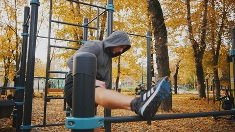 Young man doing stretching on the crossbar before training Stock Footage 96771441