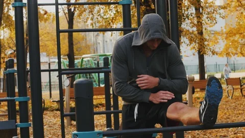 Young man doing stretching on the crossbar before training Stock Footage 96884649
