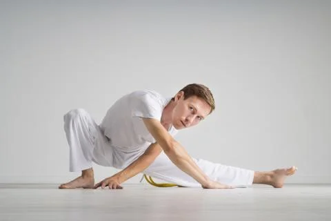 Young man doing stretching exercises Stock Photos