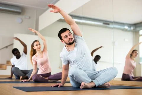 Young man doing stretching exercises in lotus position Foto stock