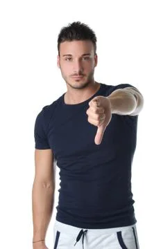 Young man doing thumb down sign Stock Photos