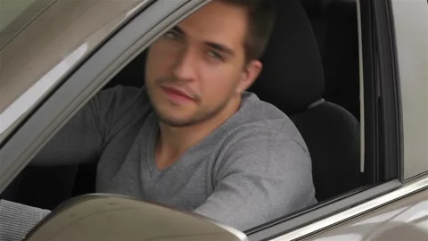 Young man doing thumps-up in car Stock Footage 252681848