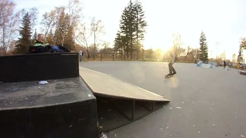 Young man doing a trick on a skateboard in a skate park Stock Footage 69789577